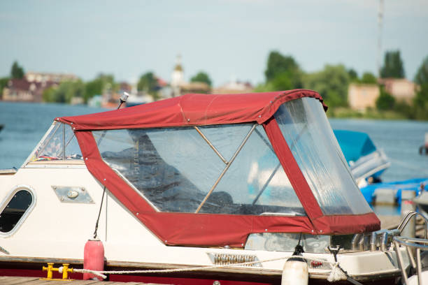 white motor boat moored at the river pier, close up