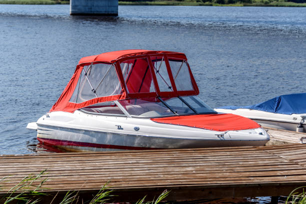small motor boat at the pier on the river near the bridge